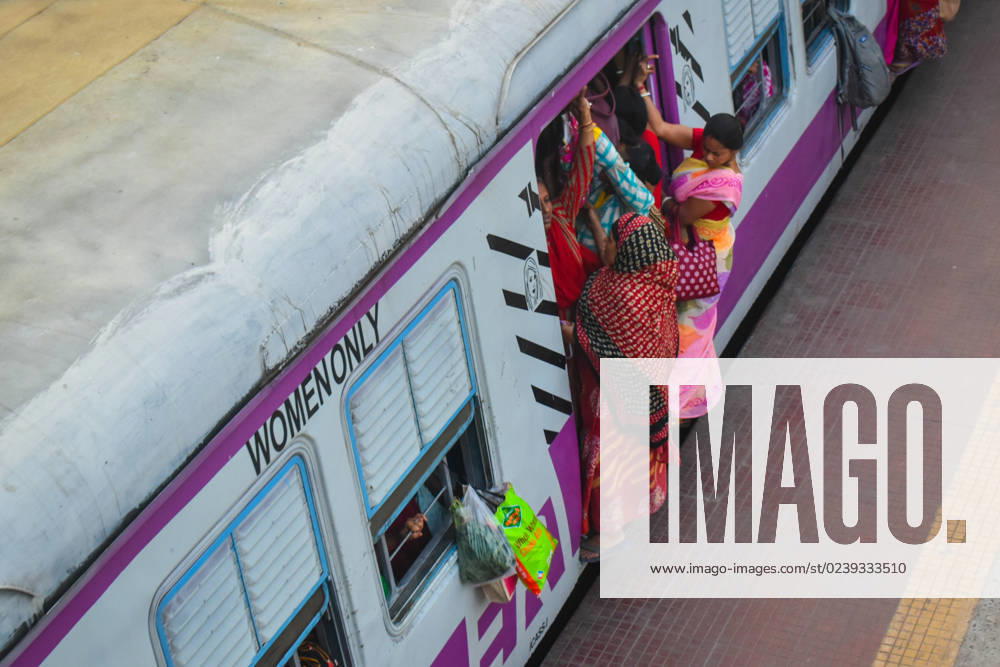 Daily Life In Kolkata Women are traveling in a dangerous way on a local train on the outskirts of Kolkata, India on March 15th, 2023. Kolkata India
