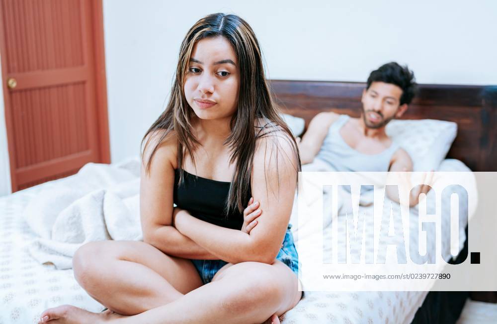 Wife disputes itself with their Man at Bed Young one pair disputes itself at the Bed sitting Concept the pair Problems at Bed excited Woman with Husband at the Bed sitting