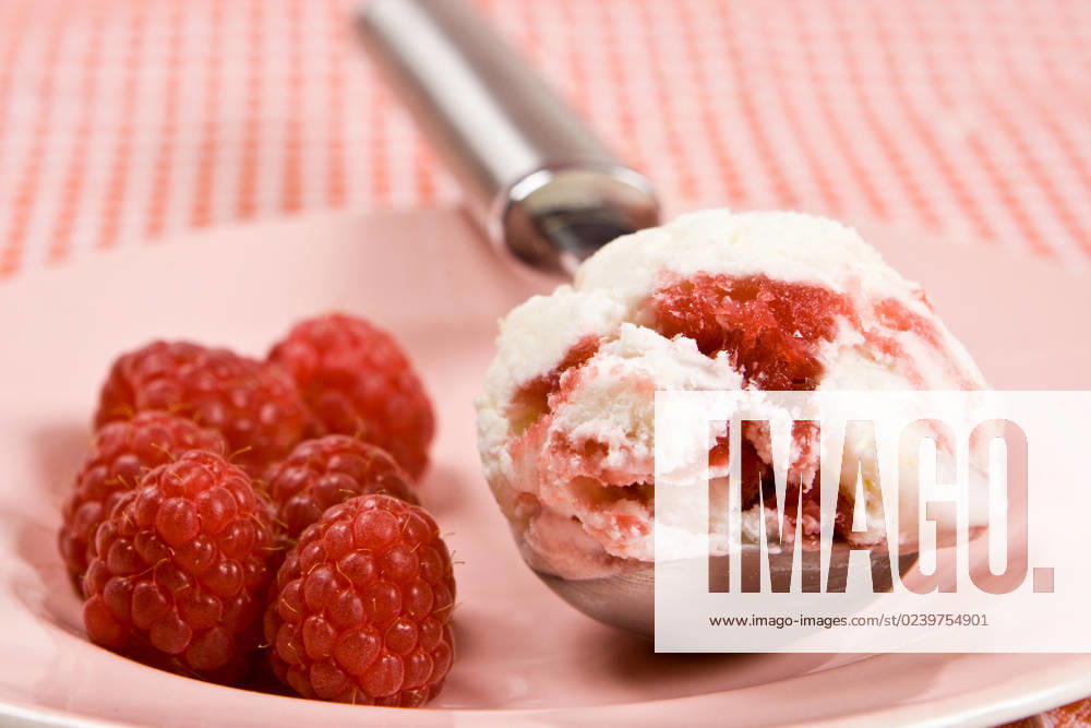 Fresh raspberries with ice cream on a plate