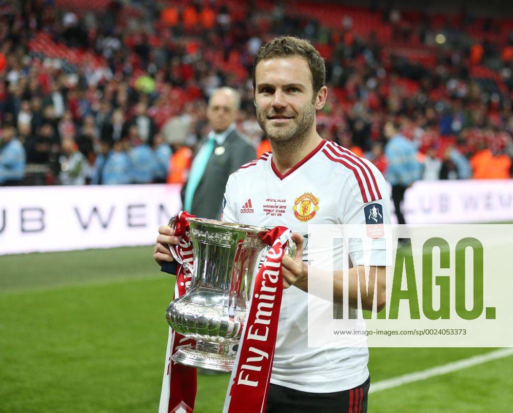 Manchester United ManU s Juan Mata celebrates with the trophy during the Emirates FA Cup Final match at Wembley Stadium. Photo credit should read: David Klein Sportimage .