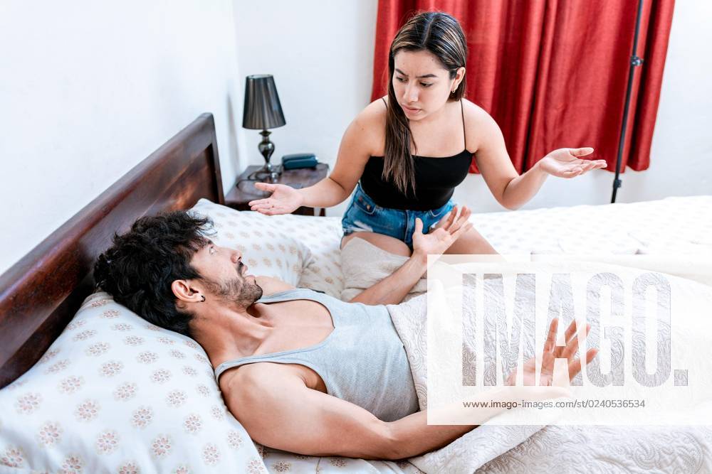 Young one pair disputes itself at Bed Room Husband disputes with its Woman at Bed Concept the pair Problems at Bed upset Woman with Man at Bedroom Bed