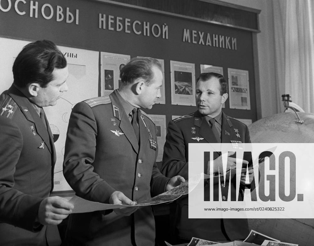 Moscow, USSR. February, 1966. Heroes of the Soviet Union, Soviet cosmonauts Pavel Popovich, Alexei Leonov and Yuri Gagarin (L-R) look at the pictures, taken by the Luna-9 space station, during the lessons at the Zhukovsky Air Force Engineering Academy. The exact date of the photograph is unknown. Valentin Cheredintsev TASS 1418445
