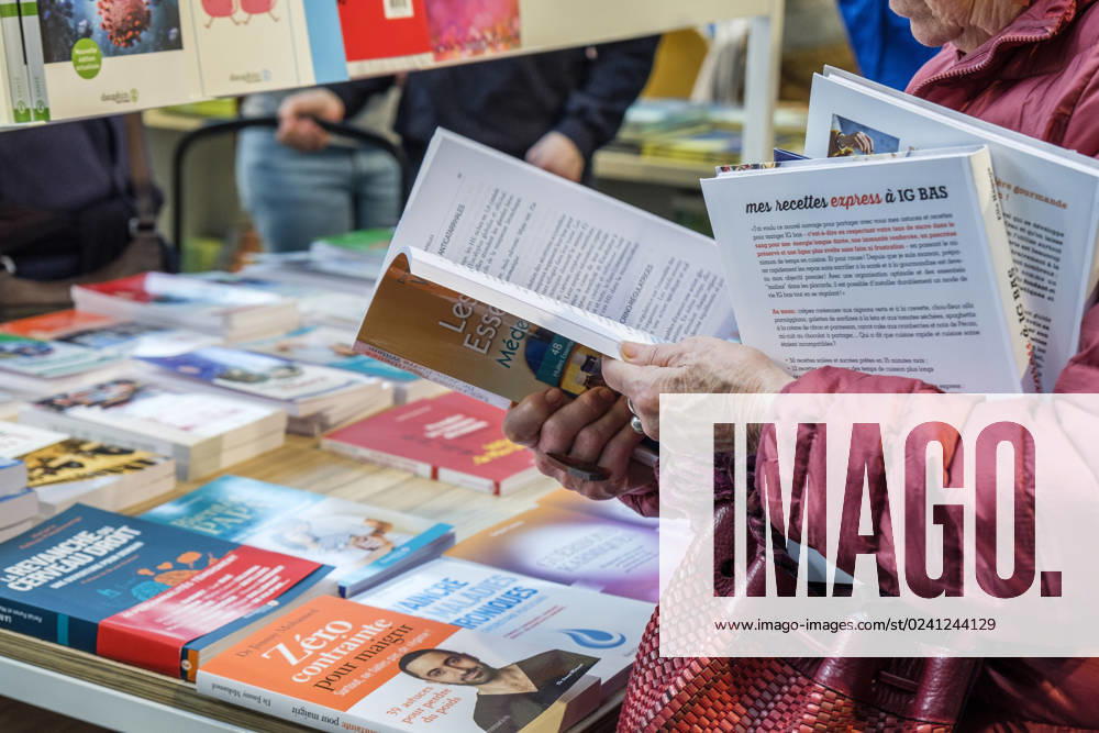 Foire du Livre de Bruxelles les gens se pressent autour des presentoirs 2023 Feuilleter un livre Brussels Books fair 2023 - Flipping the pages Reporters QUINET JEANxMARCxQUINET