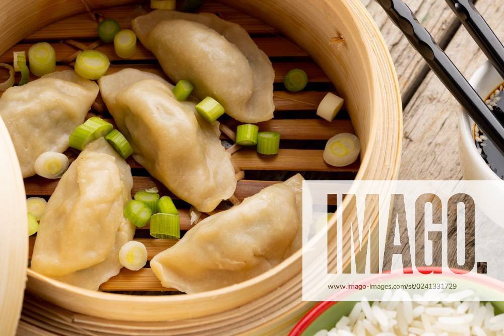 IMAGO Creative, Food, Dumplings Close up of asian dumplings, soy sauce, rice and chopsticks in wooden dish and wooden background Close up of asian dumplings, soy sauce, rice and chopsticks in wooden dish and wooden background. Asian tasty home cooked food and healthy eating., model released, , property released, Cape Town, South Africa, 14.07.2022, 3766925.jpg, close,asian,dumpling,soy sauce,rice,chopstick,wooden background,dish,tasty,home,cooked,food,healthy eating,delicious,meal,cuisine,dinner,lunch,gourmet,plate,cooking,fresh,snack,diet,nutrition,meat,healthy,vegetable,eat,sweet,sauce,restaurant,ingredient,soy,wooden,background,eating