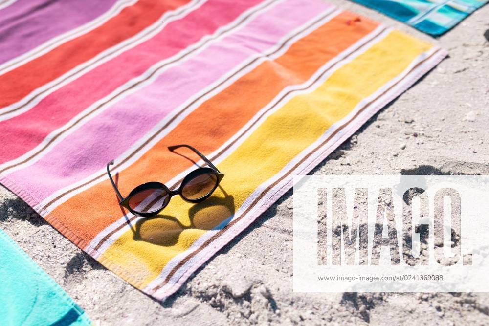 High angle view of sunglasses and colorful towel on sandy beach during sunny day High angle view of sunglasses and colorful towel on sandy beach during sunny day. Copy space, unaltered, protection, vacation, fashion, picnic and summer concept., model released, , property released, Cape Town, South Africa, 19.01.2023, 3991031.jpg, high angle,angle view,sunglass,colorful,towel,sandy beach,sunny day,copy space,unaltered,protection,vacation,fashion,picnic,summer concept,holiday,beautiful,color,summer,beauty,travel,style,beach,sea,tourism,blue,ocean,water,background,pattern,bright,art,safety,design,texture,high,angle,view,sandy,sunny,day,copy,space,concept