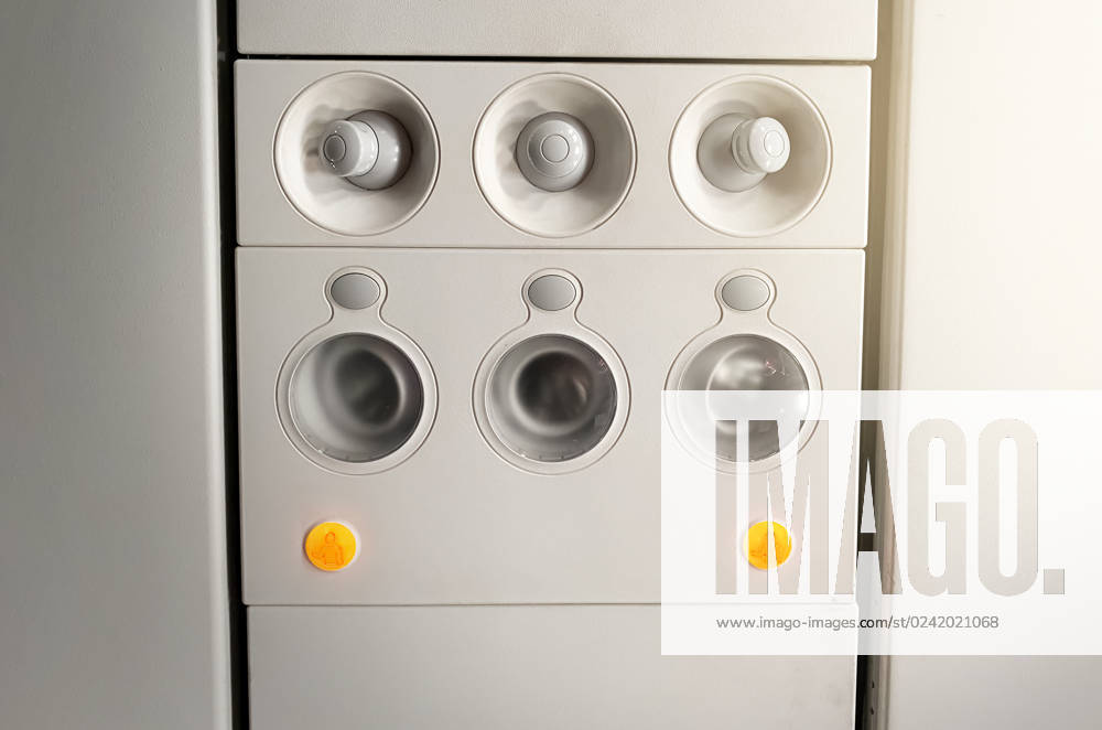 Adjustable lights and air conditioners overhead seat controls of a commercial aircraft. Closed air conditioners nozzles , 30093284.jpg, airplane, knob, passenger cabin, control panel, air vehicle, control, technology, flying, push button, no people, travel, airplane seat, seat, transportation, sign, symbol, design, safety, equipment, commercial airplane, passenger, airplane interior, airline, ceiling, aeroplane, console, ventilation, conditioning, conditioner, board, fly, aircraft, panel, button, interior, cabin, flight, overhead, plane, nozzles, closed, round, adjustable, icon, light, transport, seating, nobody, security, plastic,