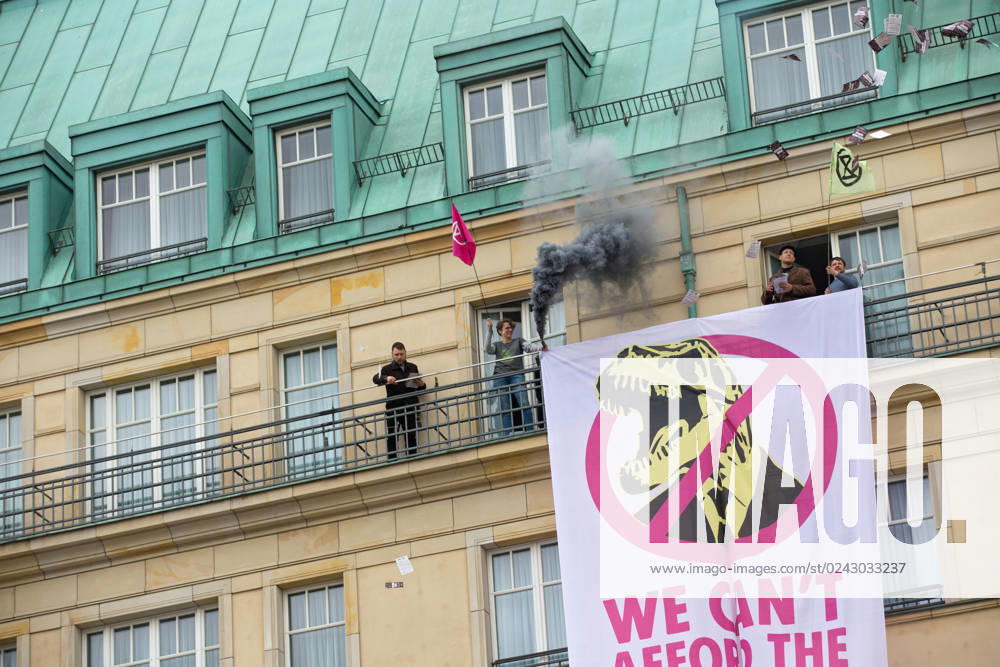 Berlin, Germany, DEU Extinction Rebellion, climate activists hijack Hotel Adlon 13.04.23, Berlin, Germany, DEU Extinction Rebellion, climate activists hijack Hotel Adlon Demonstrators add smoke candles and unfurl a banner on the balcony of one of the upper floors that reads We cant afford the super rich Berlin Berlin Germany