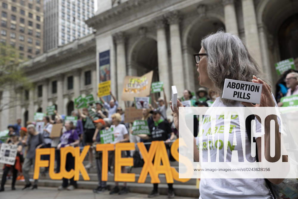 A protester holds a box that reads Abortion Pills. A sign reads â€oeFuck Texas.†On a national day of action to protest the court battle to restrict access to mifepristone, used for medication abortion, pro-abortion activists rallied on the steps of the 42nd St branch of the New York Public Library to call for an end to abortion bans. New York USA - ZUMAr174 20230415_znp_r174_079
