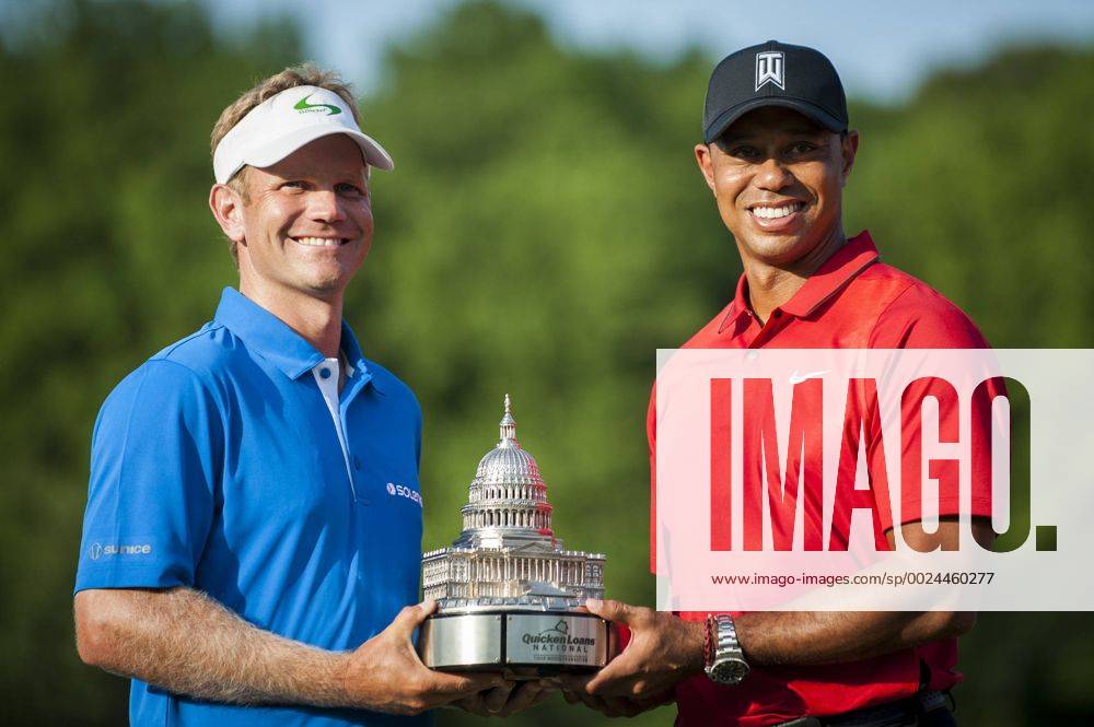 Billy Hurley III, of Annapolis, Maryland, holds the Quicken Loans National Trophy with tournament host, Tiger Woods, following the final round of the Quicken Loans National golf tournament at Congressional CC in Bethesda, Maryland on Sunday, June 36, 2016. Hurley shot a 2-under 69 on Sunday for his first tournament win. WAP201606261084 PETExMAROVICH