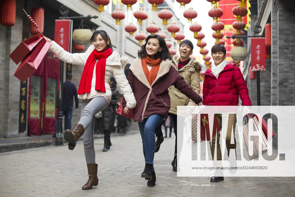 Happy young Chinese friends shopping for Chinese New Year Beijing China