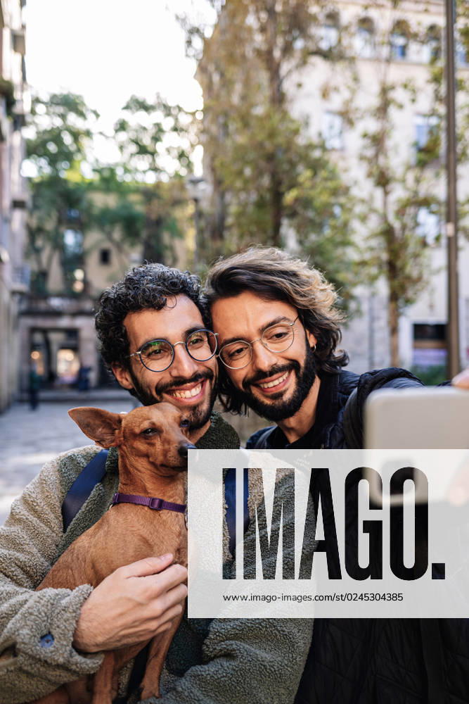 Smiling gay couple taking selfie with dog model released, Symbolfoto property released, GDBF00058