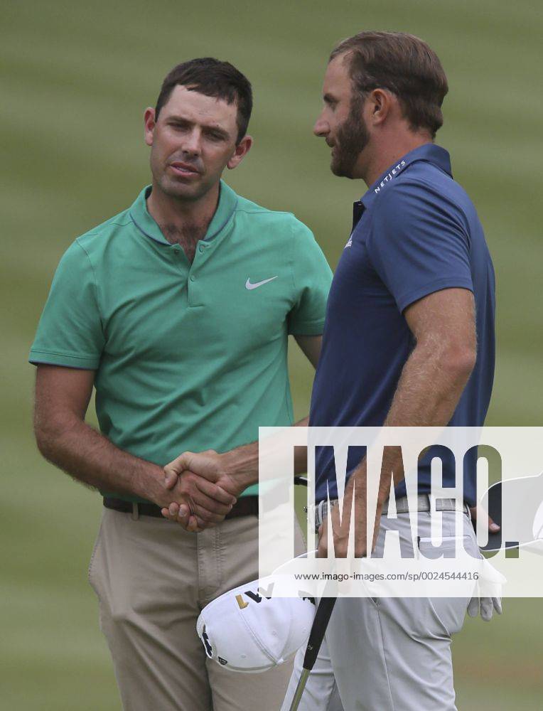 Akron, OH, USA - Winner Dustin Johnson, right, shakes hands with Charl Schwartzel, who finished tied for seventh, on the 18th hole on the final day of the Bridgestone Invitational golf tournament on Sunday, July 3, 2016, at Firestone Country Club in Akron, Ohio. Bridgestone Invitational - ZUMAm67_