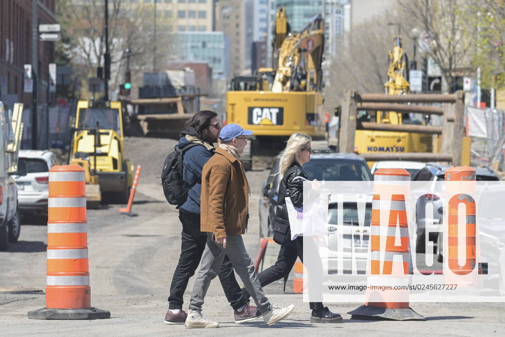 People walk by construction cones in Montreal, Tuesday, April 25, 2023. The Quebec government has vowed to remove the cones after 72 hours of inactivity. Montreal Canada - ZUMAc35_ 20230425_zaf_c35_052