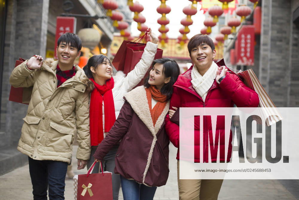 Happy young Chinese friends shopping for Chinese New Year Beijing China