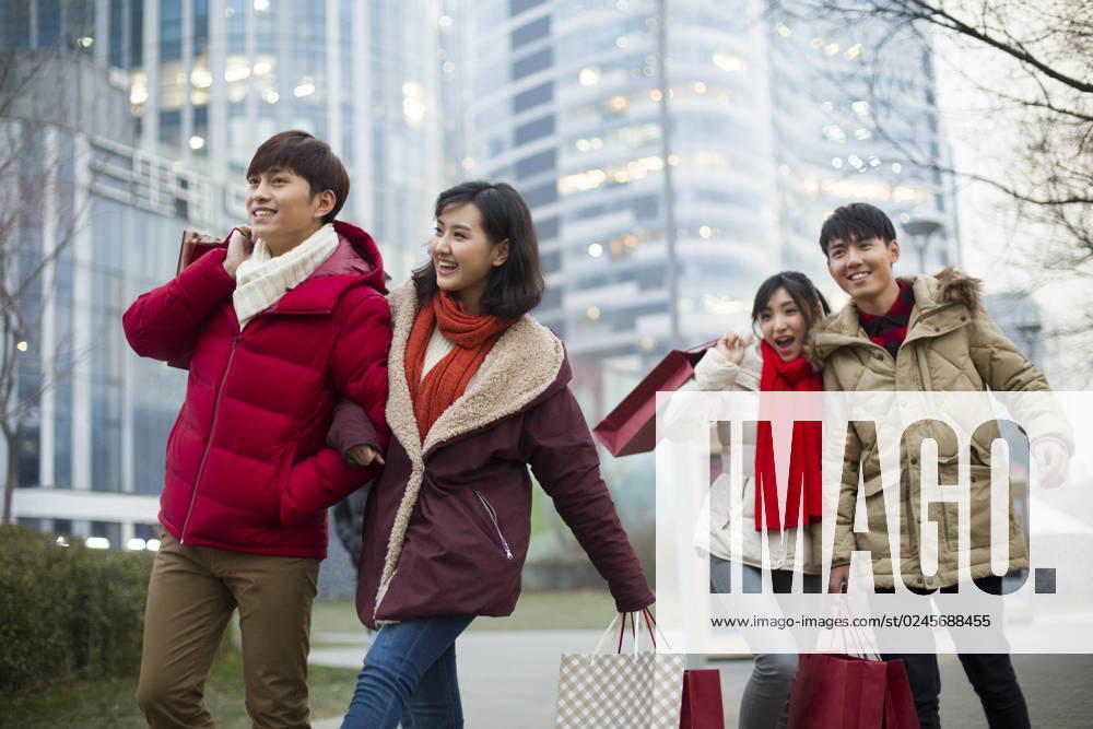 Happy young Chinese friends shopping for Chinese New Year Beijing China