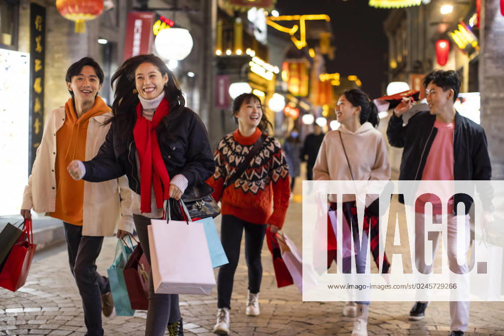 Happy young Chinese friends shopping for Chinese New Year Beijing China