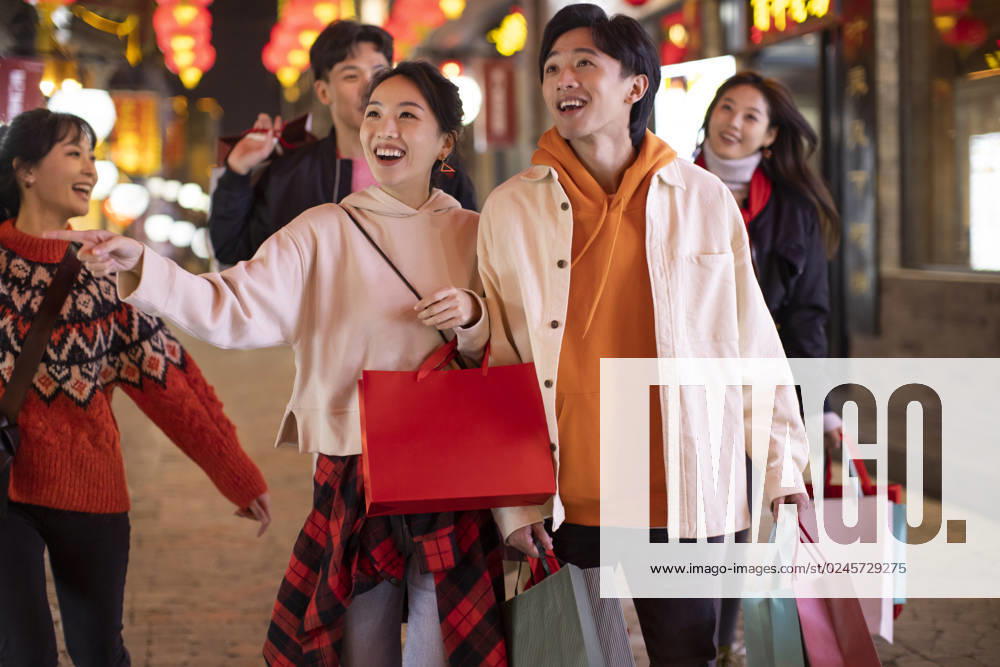 Happy young Chinese friends shopping for Chinese New Year Beijing China
