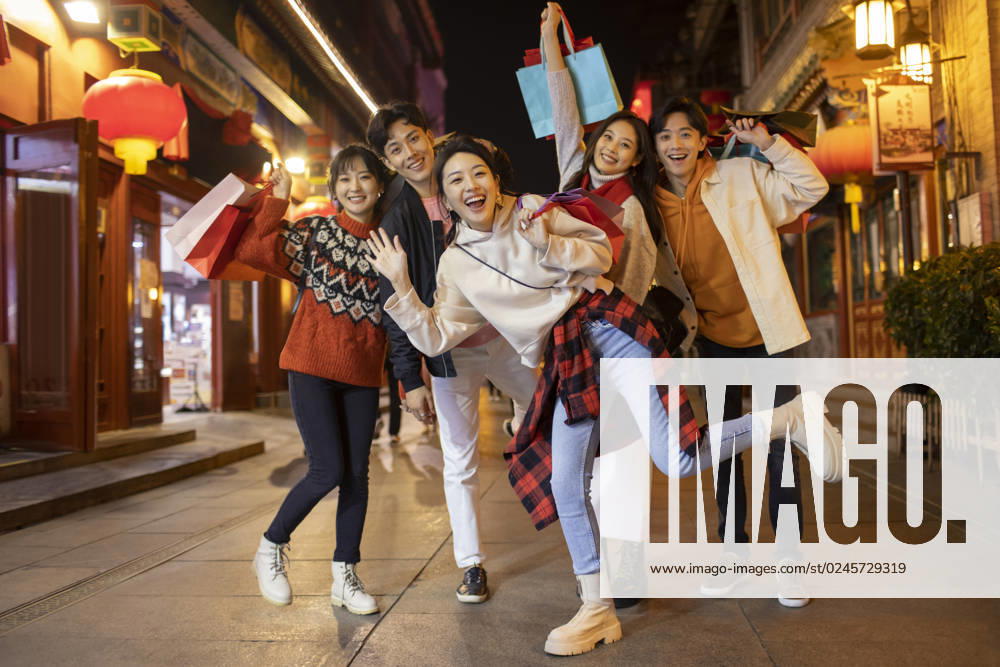 Happy young Chinese friends shopping for Chinese New Year Beijing China