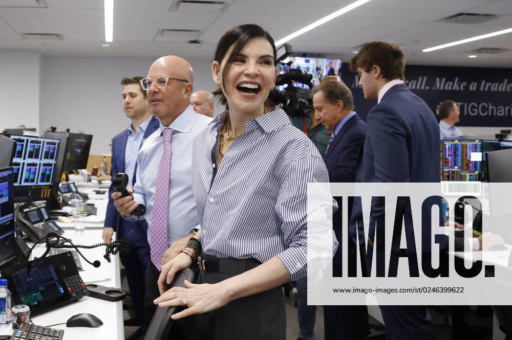 BTIG Co-Founder Steven Starker and actress Julianna Margulies speak to a client at the 2023 BTIG Commissions for Charity Day in New York City on May 2, 2023. NYP20230502110 JOHNxANGELILLO