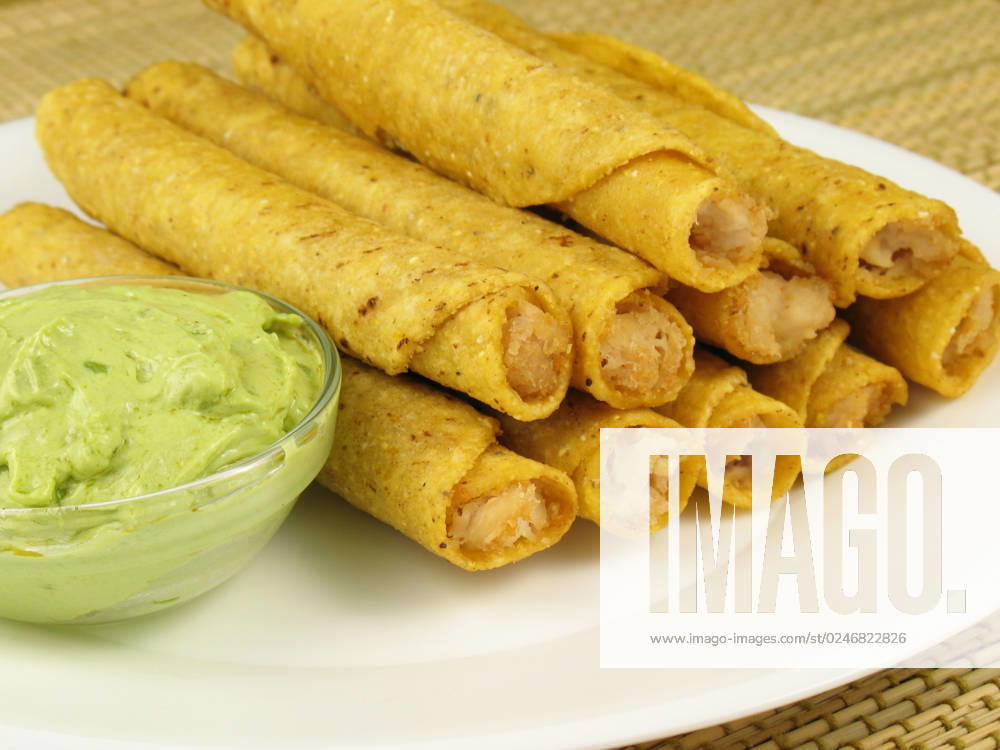 IMAGO Creative, Food, Taquitos A plate of chicken taquitos with a side of guacamole.