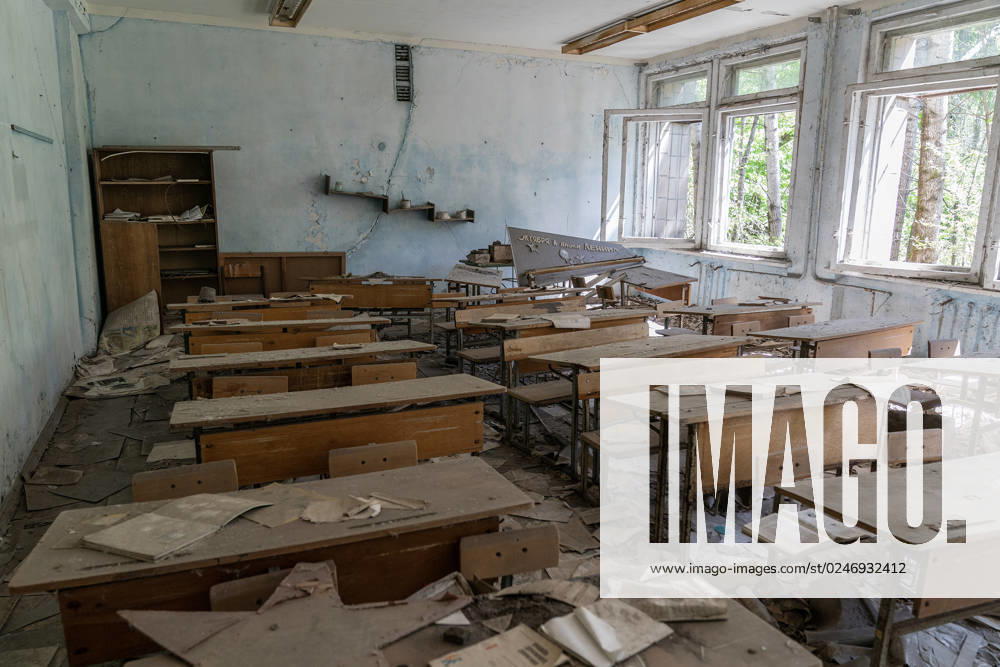 Abandoned city of Pripyat and closed Chernobyl nuclear plant View of interior of classroom with desks and books on student s desks in school in abandoned city of Pripyat in Ukraine from where all dwellers were evacuated after disaster on Chernobyl nuclear plant. Ukraine