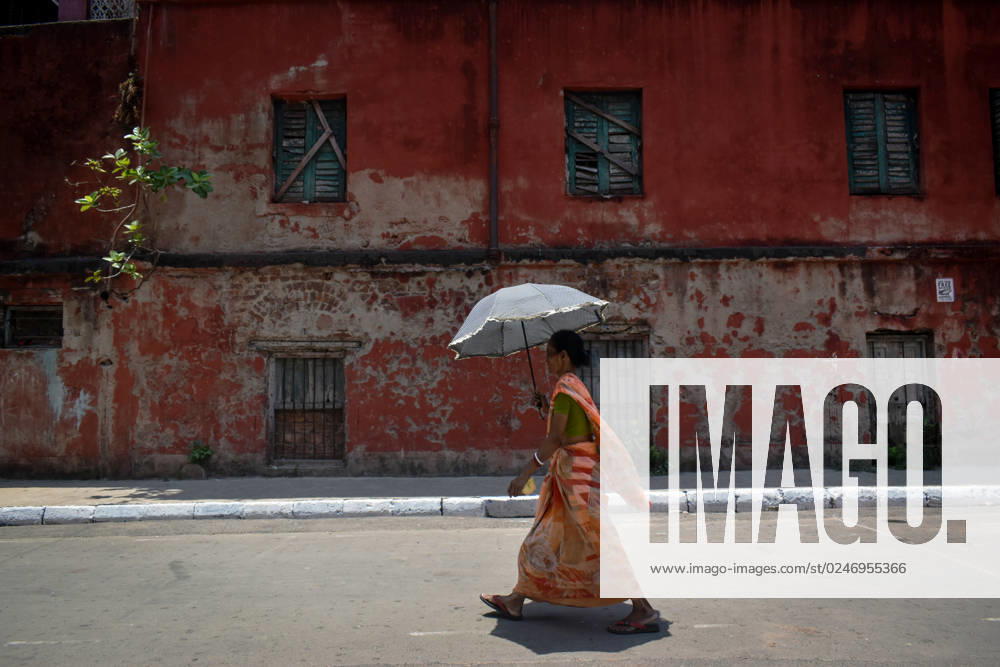 Daily Life In Kolkata A woman is walking down the street with an umbrella during a heat wave in Kolkata, India on May 7, 2023. Kolkata India
