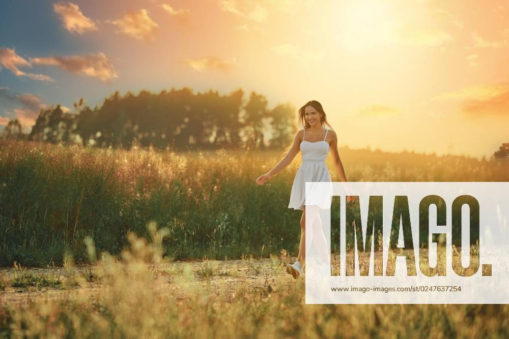 Happy Boy Woman, the at Sunset at a Meadow along the Country road walked