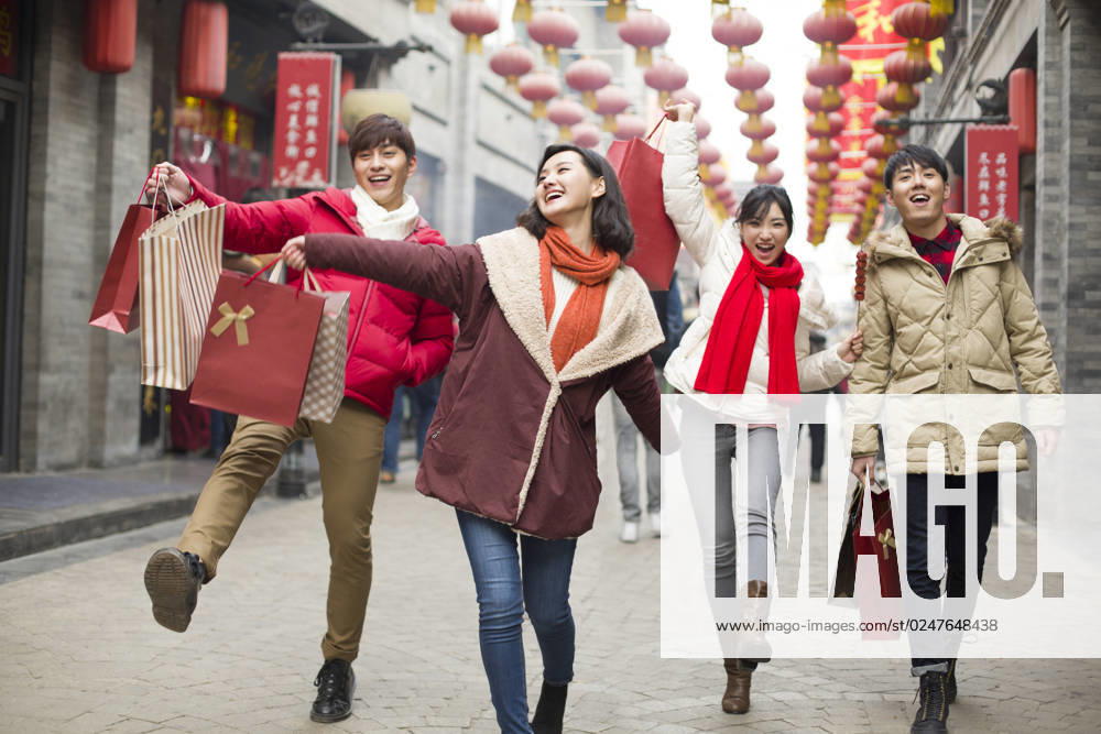 Happy young Chinese friends shopping for Chinese New Year Beijing China