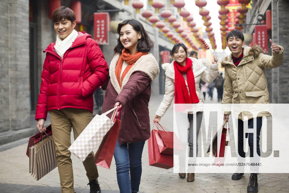 Happy young Chinese friends shopping for Chinese New Year Beijing China