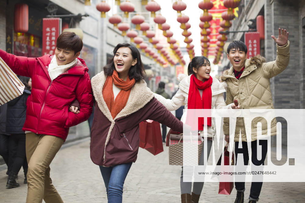 Happy young Chinese friends shopping for Chinese New Year Beijing China