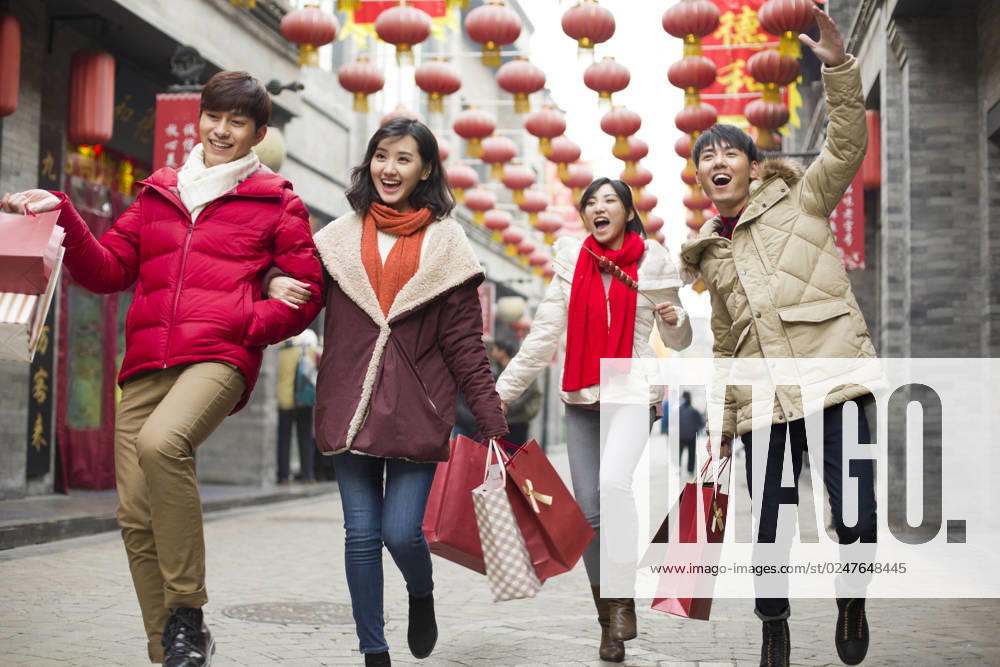 Happy young Chinese friends shopping for Chinese New Year Beijing China