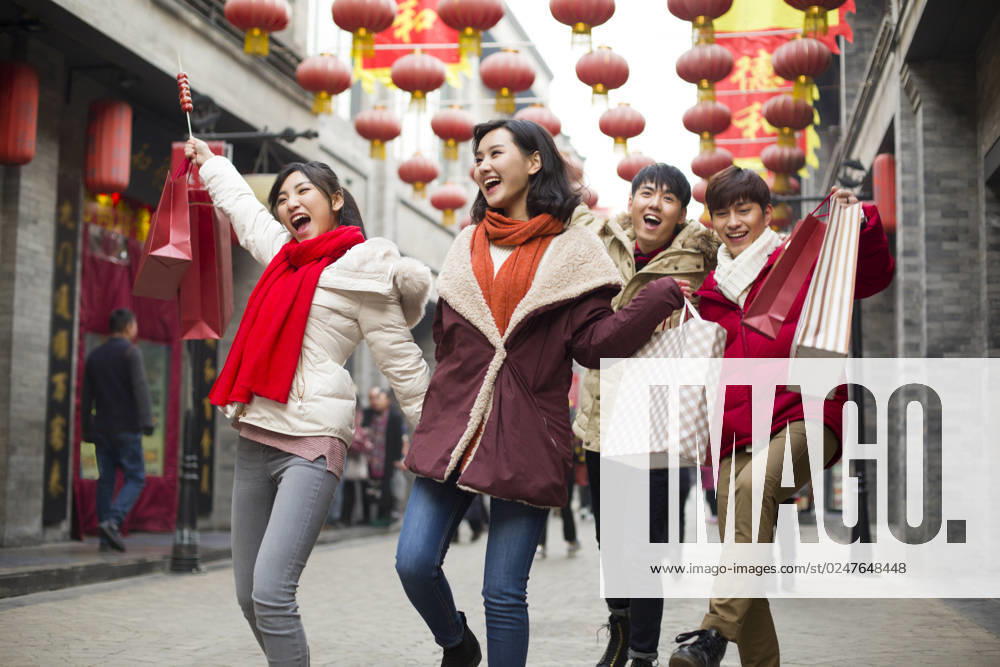 Happy young Chinese friends shopping for Chinese New Year Beijing China