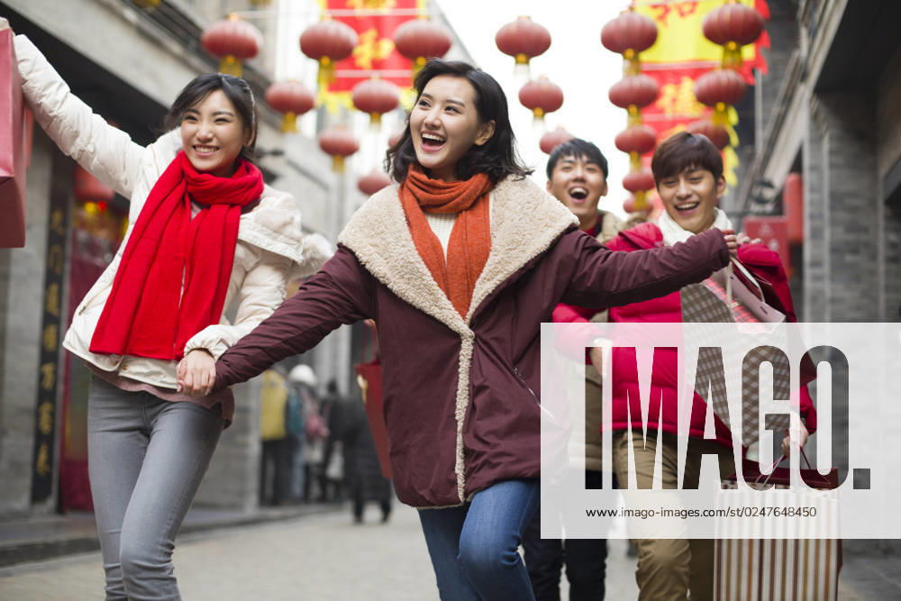 Happy young Chinese friends shopping for Chinese New Year Beijing China