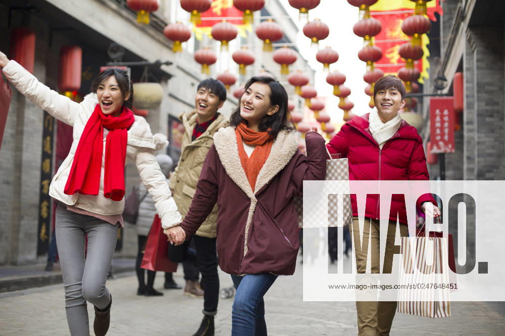 Happy young Chinese friends shopping for Chinese New Year Beijing China