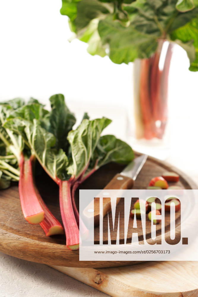 Bunch of fresh organic rhubarb on wooden board