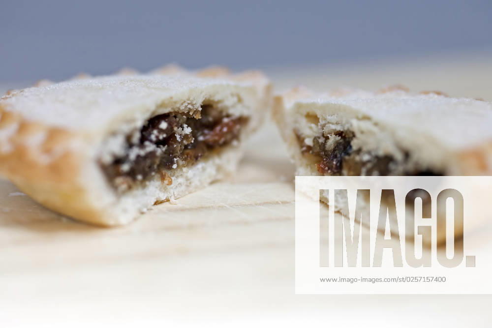 Side up and close view of fresh crusty mince pie cut in half to show filling