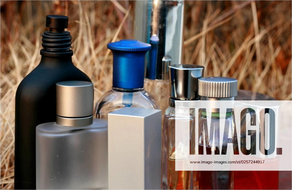 Assorted Fragrances bottles in an outdoor dried grass background