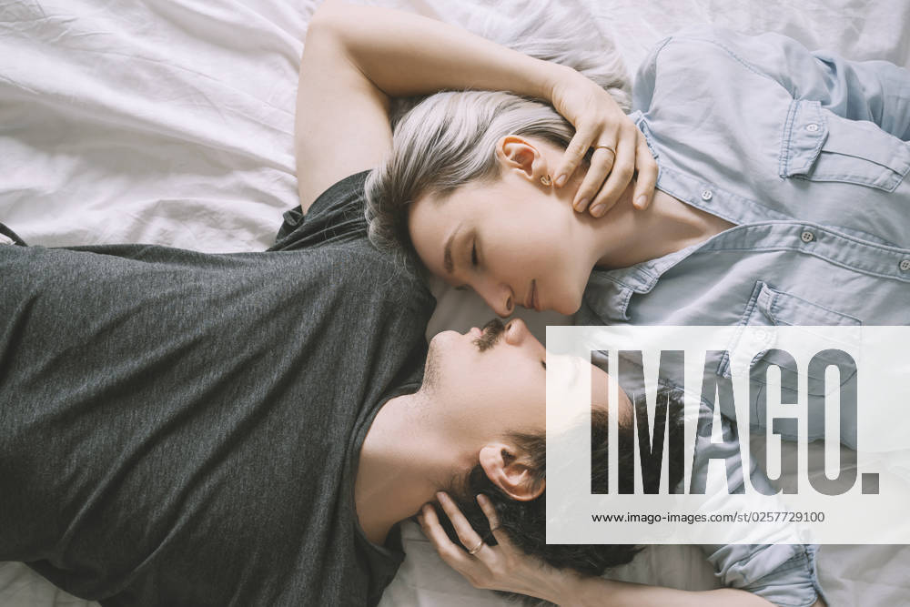 Man and woman lying on bed and embracing each other model released, Symbolfoto property released, NDEF00553