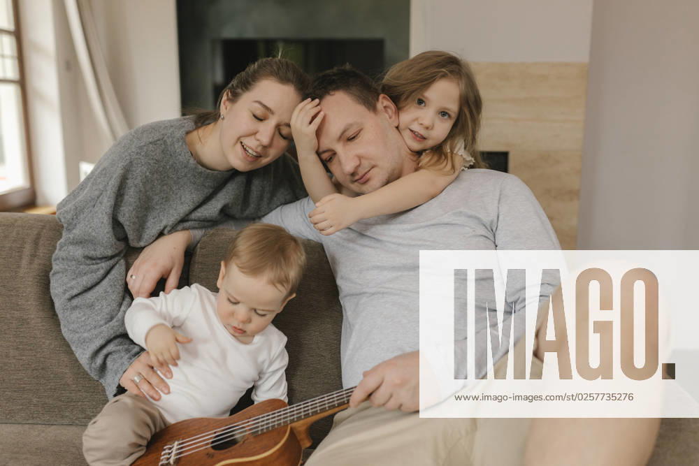 Family spending leisure time with ukulele in living room model released, Symbolfoto property released, VIVF00829