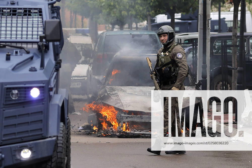 Clashes between ethnic Serbs and Kosovo Police A Kosovo Police Special Unit officer walks near a burning car in Zvecan, Kosovo, on May 26, 2023. Clashes between ethnic Serbs and Kosovo Police began after the Serbs gathered in front of the municipality building trying to block the entrance to recently-elected officials. Stringer PIXSELL