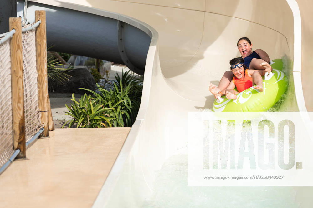 MR_ID14021_13418_ArhaneUnzueta.jpg, MR_ID14021_13419_KatixaIntxausti.jpg Screaming children in bathing suits riding a yellow inflatable ring on a scary water slide while looking down and enjoying the summer, Model released HodeiUnzueta_ID14021_423032_016