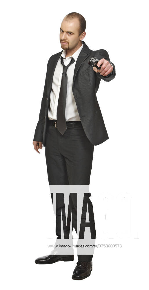Portrait of young businessman standing with pistol isolated on white