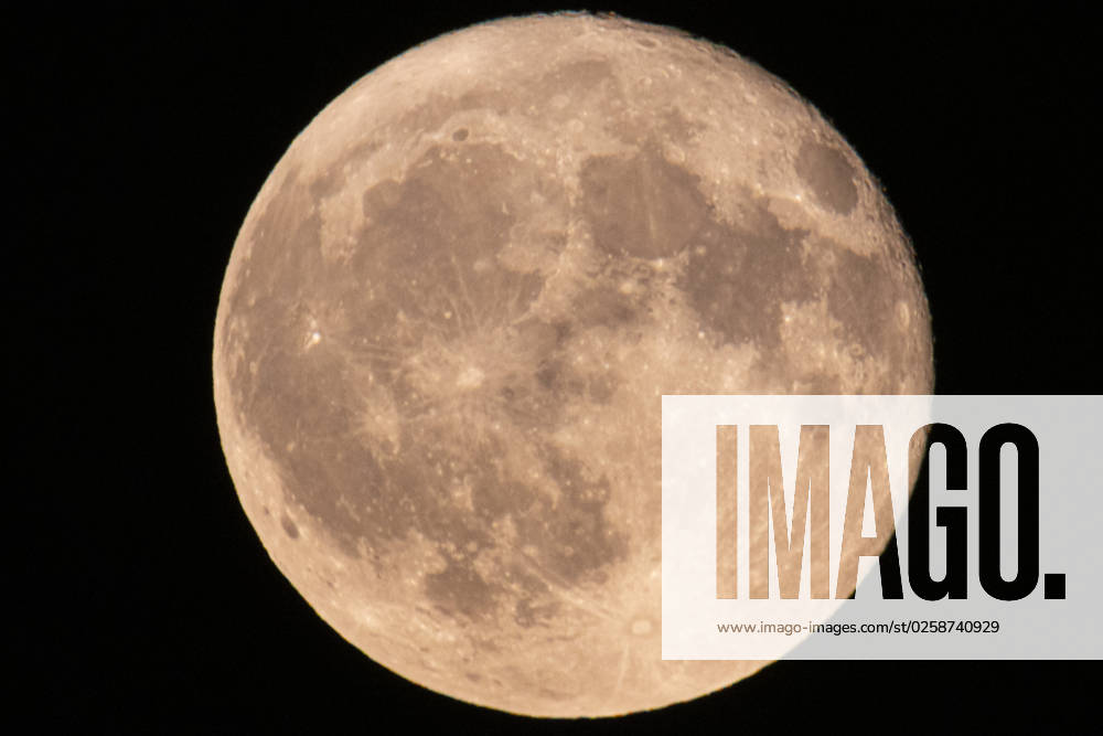 Strawberry Full Moon Rises Over The Netherlands Colorful pink Strawberry moon illuminates the night sky. Close-up of the June full moon, nicknamed as Strawberry moon as seen rising over residential area near the Dutch city of Eindhoven, between buildings and street lights. The moon, Luna our earth s natural satellite is illuminating the night sky. The Moon is an astronomical body orbiting Earth and is the planet s only natural satellite known as Selene or Luna. Eindhoven, Netherlands on June 2023 Eindhoven Netherlands