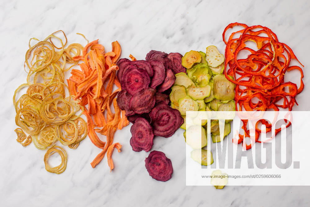 Dehydrated vegetables heap isolated on white as a snack for vegetarians Dehydrated vegetables heap isolated on white background