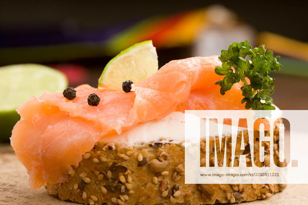 Photo of delicious crispy cereals bread with smoked salmon
