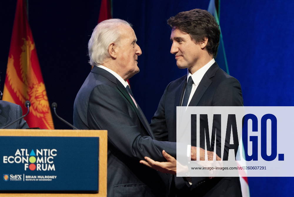 Prime Minister Justin Trudeau, right, and former prime minister Brian Mulroney share a moment on stage during the Atlantic Economic Forum at St. Francis Xavier University in Antigonish, N.S. on Monday, June 19, 2023. Antigonish Canada - ZUMAc35_ 20230619_zaf_c35_077