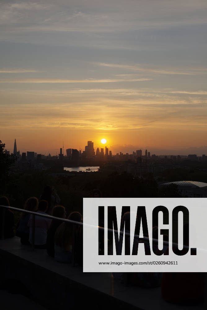 General view as people gather on the Summer Solstice (21st June) and watch a sunset over London seen from Greenwich Park, London. Greenwich London England Greenwich Park