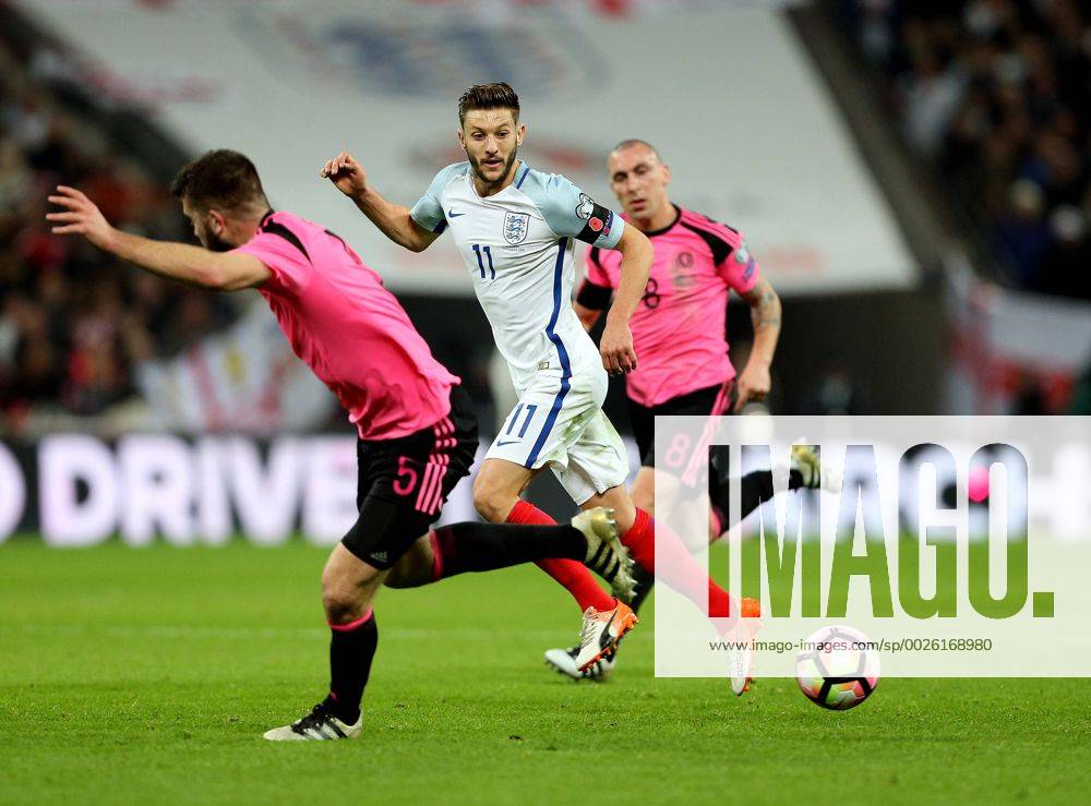 Adam Lallana of England passes the ball behind Grant Hanley of Scotland during the FIFA World Cup WM Weltmeisterschaft Fussball Qualifying Group F match at Wembley Stadium, London. Picture date: November 11th, 2016. Pic David Klein Sportimage .