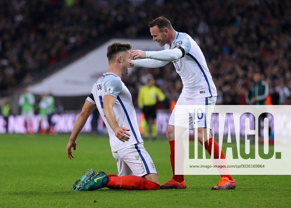 Wembley Stadium, London, England. World Cup Qualifying Football. England versus Scotland. Gary Cahill of England celebrates with Wayne Rooney of after heading past Scotland Goalkeeper Gordon Greer and making it 3-0 Kertonx ActionPlus11808499