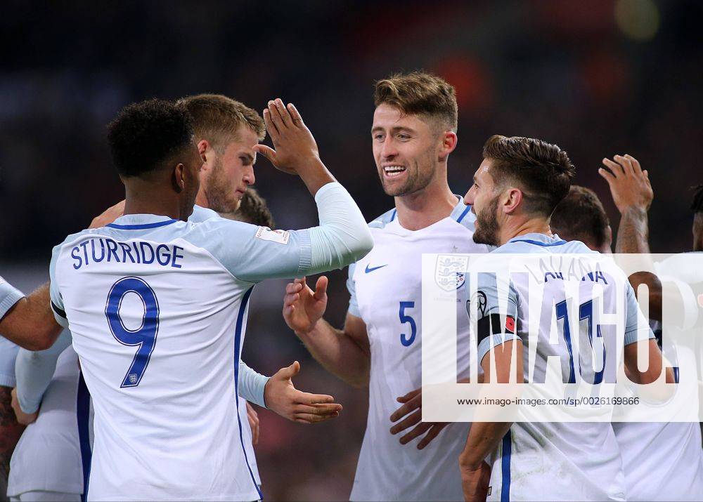 Wembley Stadium, London, England. World Cup Qualifying Football. England versus Scotland. Gary Cahill celebrates with Adam Lallana and Daniel Sturridge after heading past Scotland Keeper Craig Gordon making it 3-0 Kertonx ActionPlus11808501